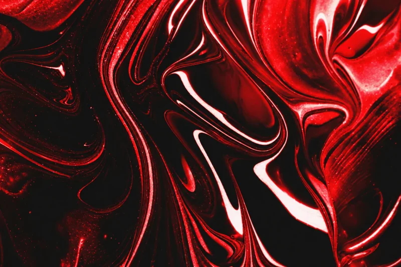 Glossy red and black liquid marbling with bright highlights